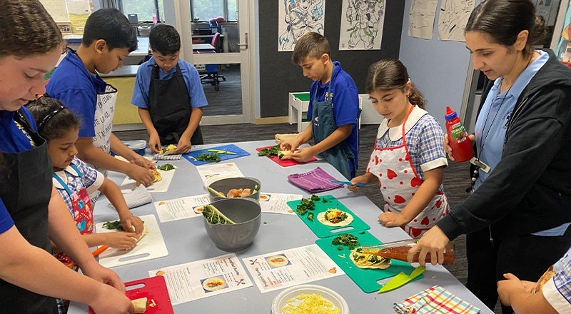 Students participating in a cooking class at Our Lady of Mount Carmel Primary School Wentworthville